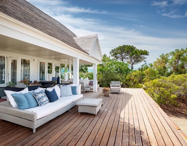 spacious backyard patio with built-in seating and shade structures created by professional patio builders in Hamilton